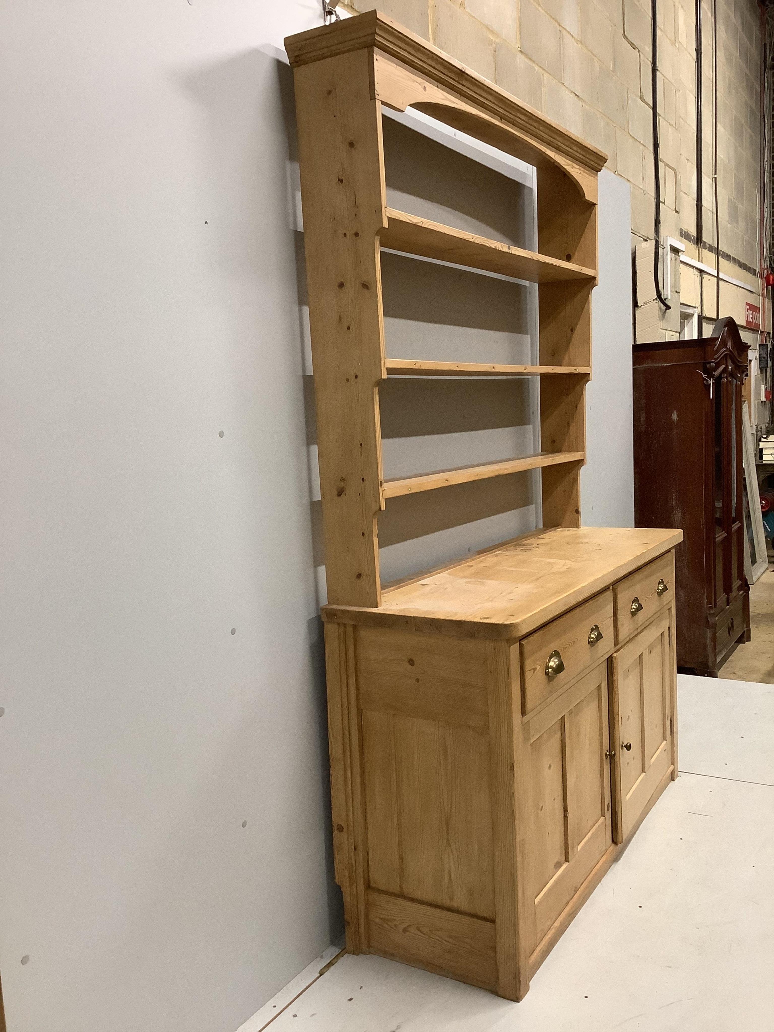 A Victorian pine dresser with open rack, width 152cm, depth 51cm, height 221cm. Condition - fair to good.